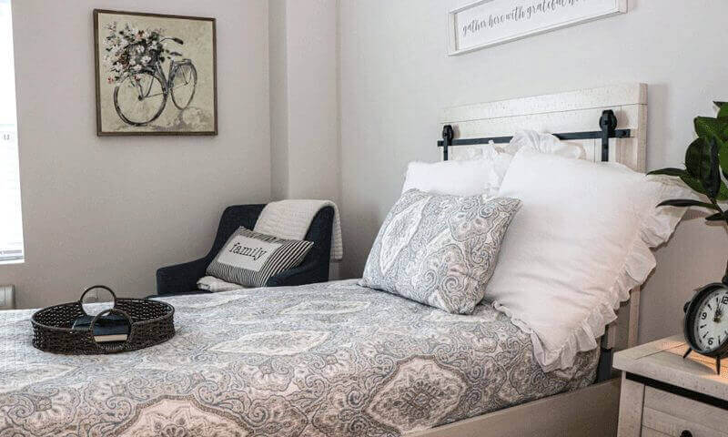 Comfortable bedroom with a chair, twin bed and nightstand