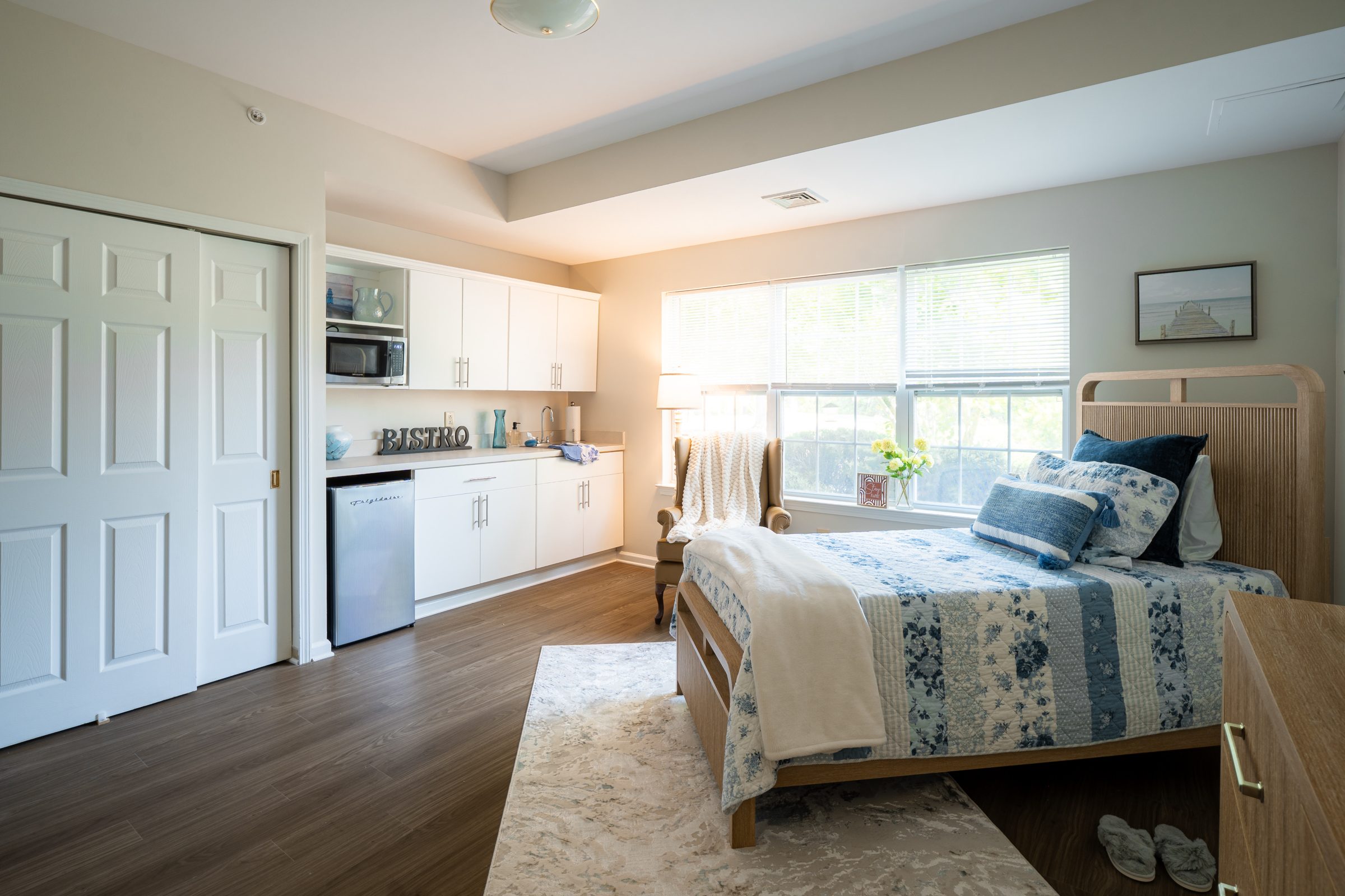 Assisted living apartment bedroom with kitchenette