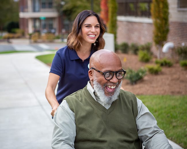 resident taking photos with caregiver