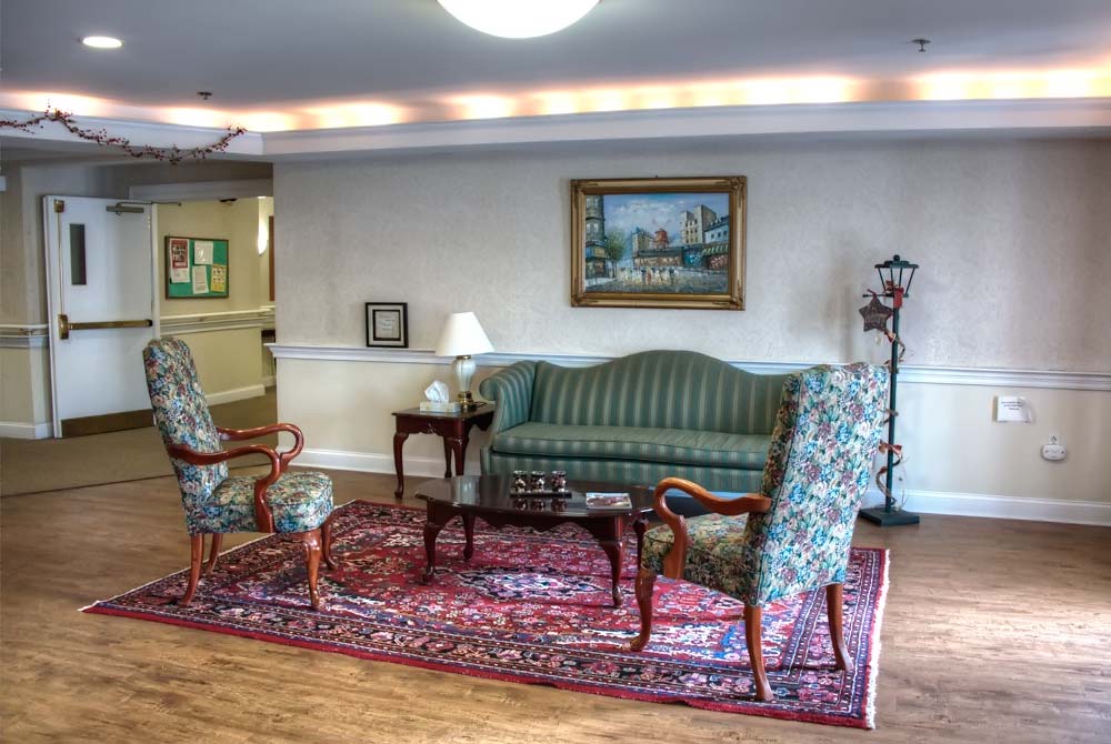 Sitting area in the lobby with couch and two chairs