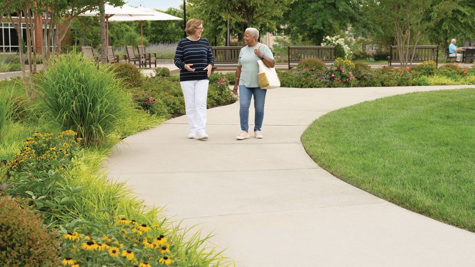 Two residents enjoying an outdoor walking path